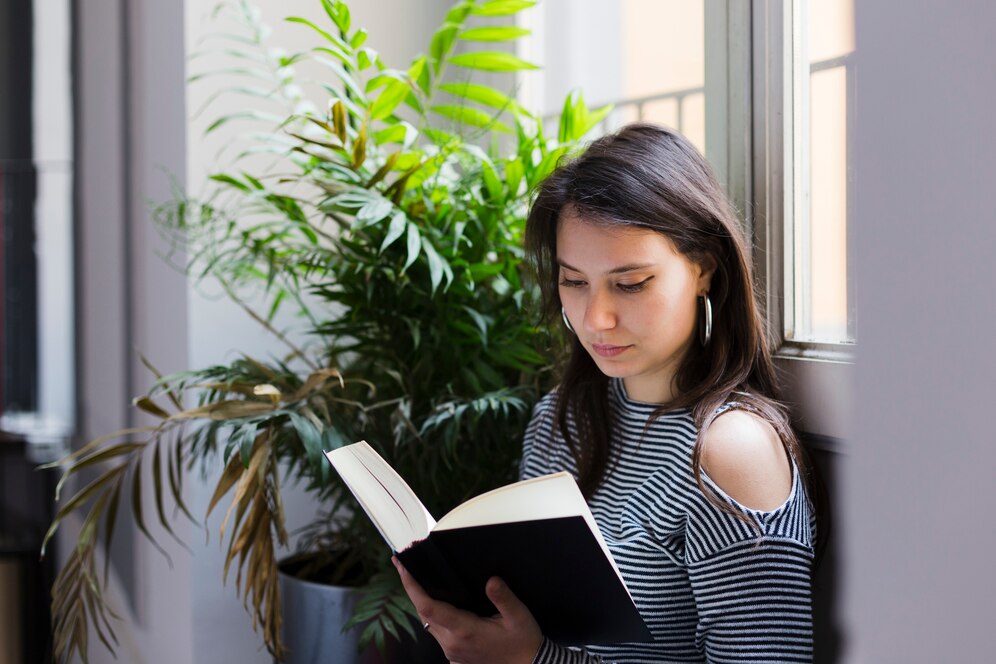 Reading Books Good or Bad: A person reading a book in a cozy setting, surrounded by bookshelves, symbolizing the balance between benefits and drawbacks of reading.