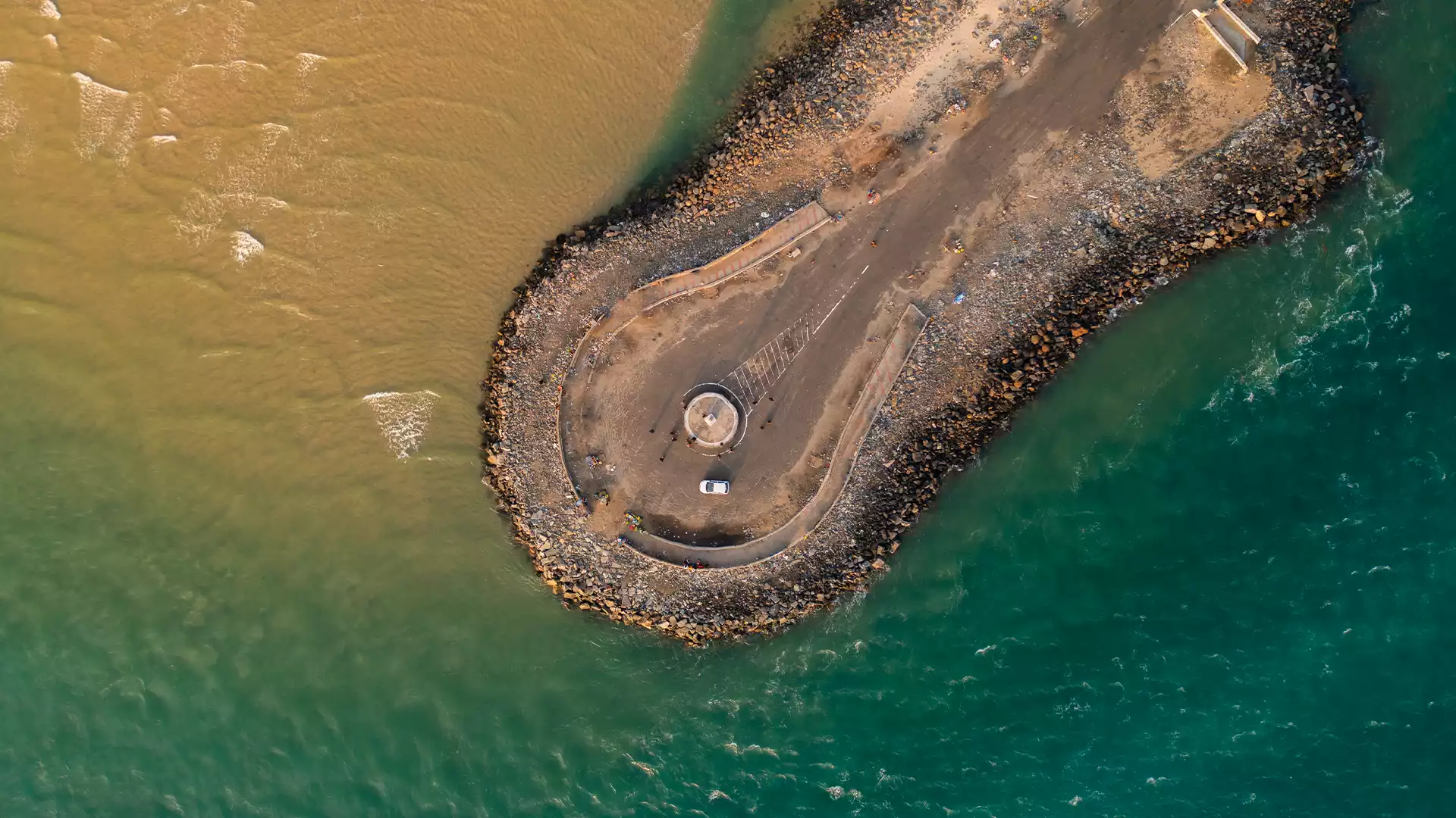 Stunning view of Dhanushkodi Beach with clear blue waters, golden sands, and a serene sky